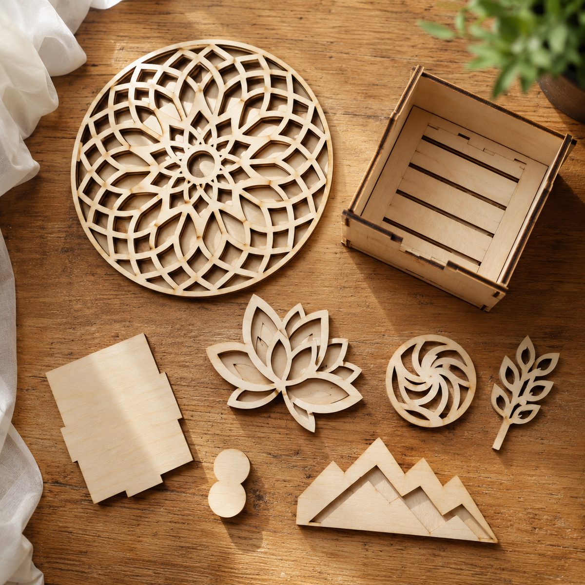 Flat lay of several laser cut plywood patterns arranged on a warm wooden workbench, top-down natural light