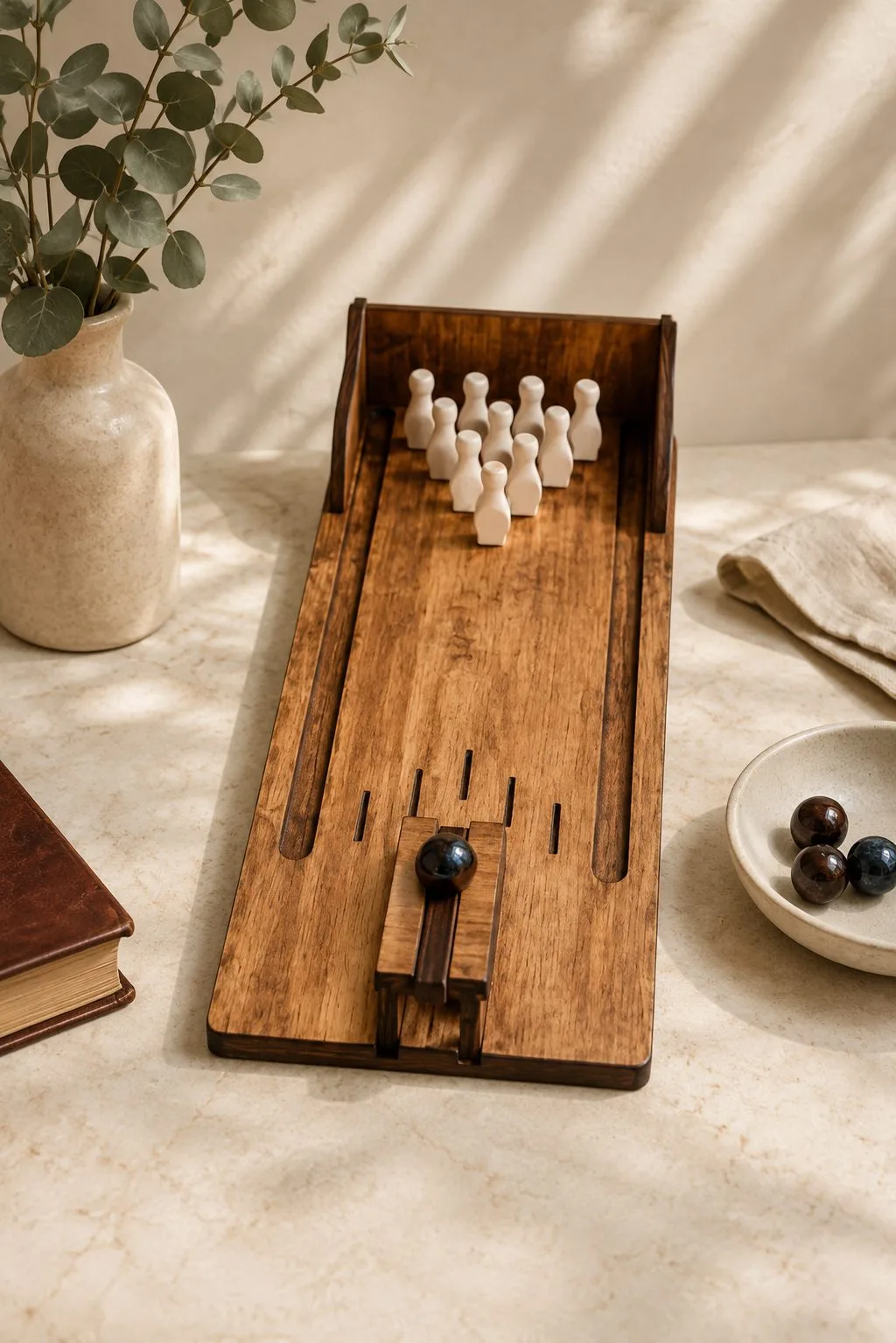 A wooden tabletop bowling lane with ten pins and a launcher, free laser cut SVG from svgdiy.com