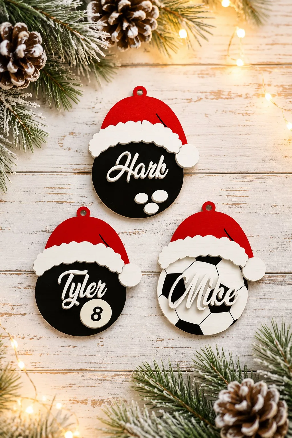 Wooden billiard ball and soccer ball ornaments in Santa hats with engraved names, free laser cut SVG from svgdiy.com