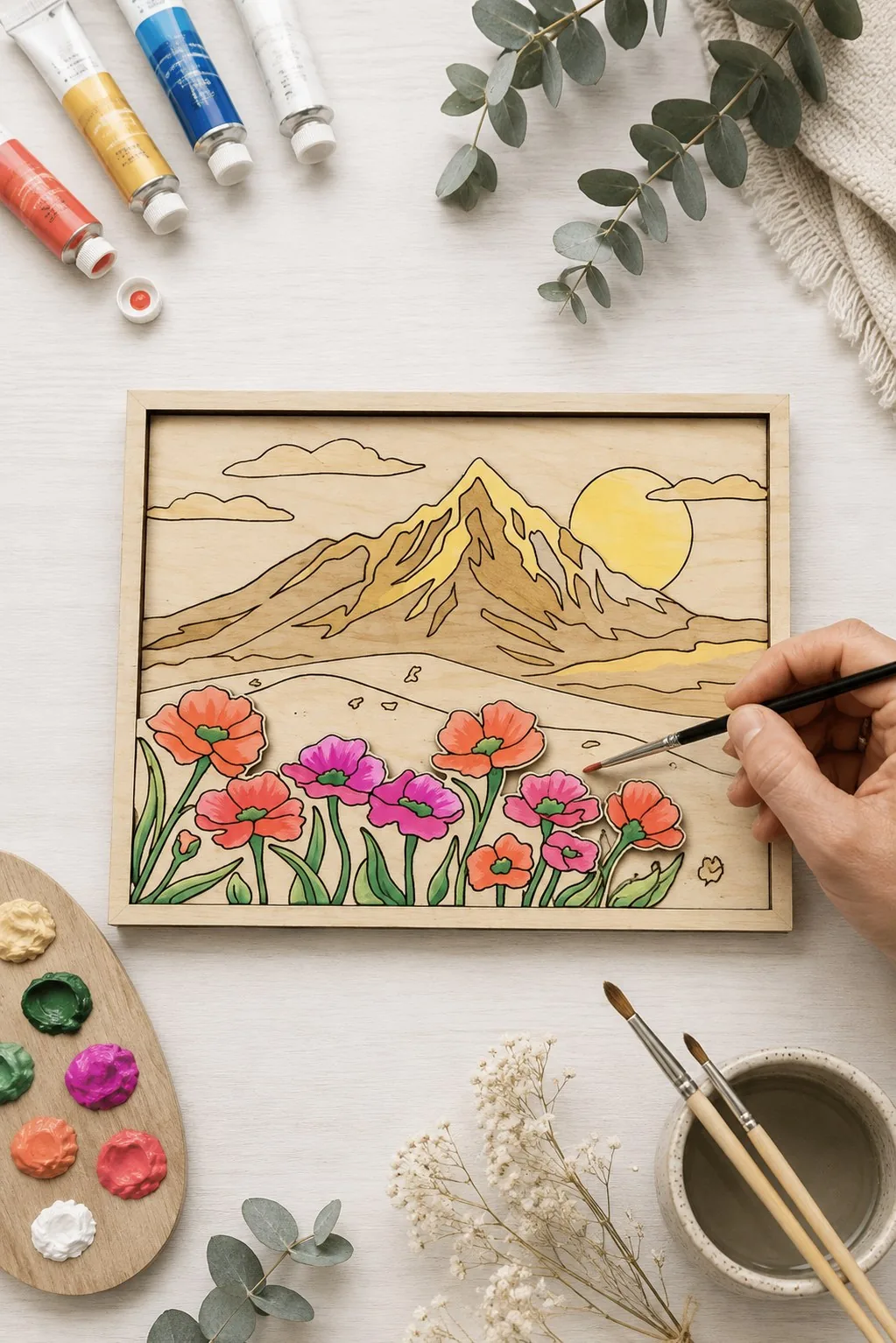 Layered wooden panel with a sunny mountain peak over a field of pink and red poppies, being painted, free laser cut SVG from svgdiy.com