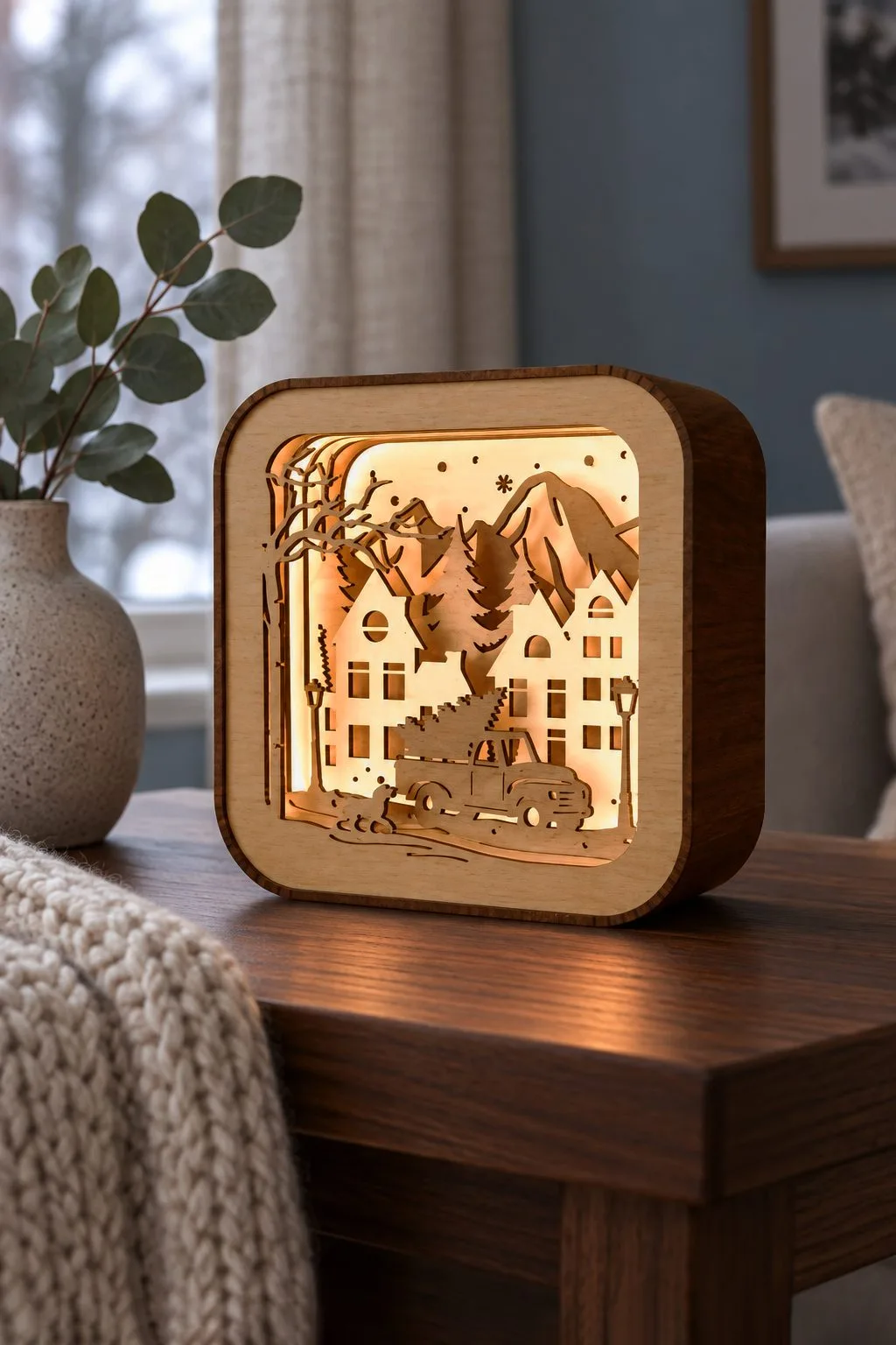 The glowing church shadow box lantern on a stone shelf, free laser cut SVG from svgdiy.com